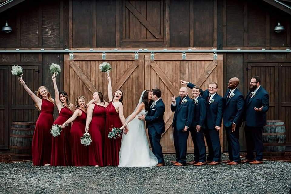 About About Us elf bridal party in front of barn Ridgeview Event Center Asheville NC